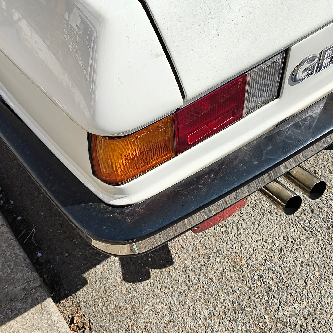 the back of a car with exhaust pipes