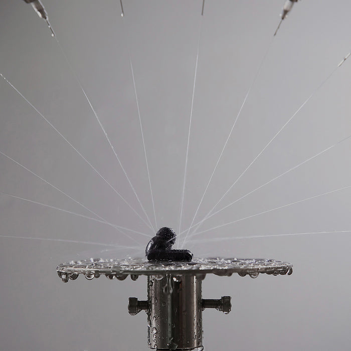 a sprinkler with water droplets coming out of it